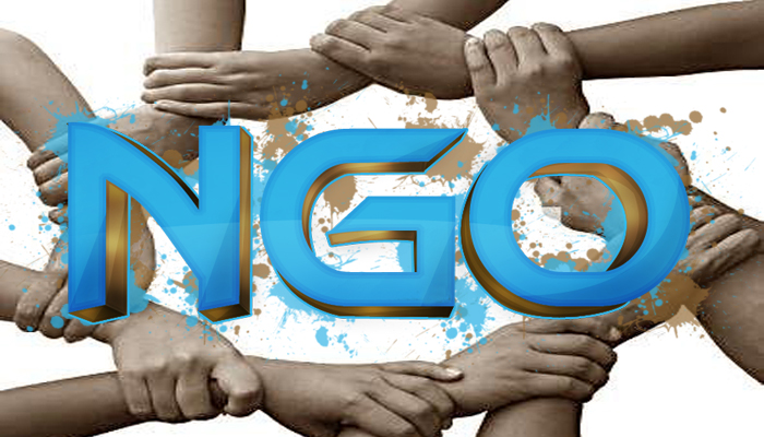 Hands of several people clasped in a chain around the letters: NGO.